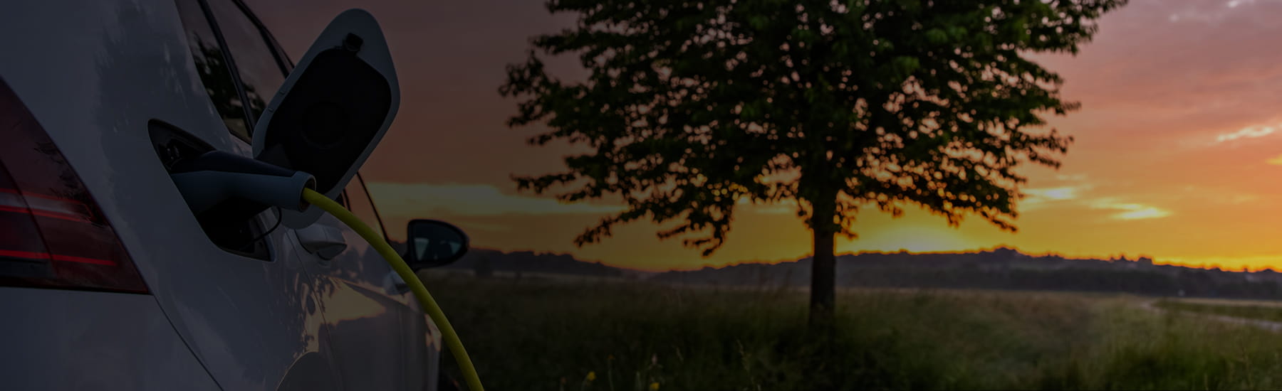 An electric vehicle charging, desktop hero.